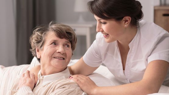 A nurse looking after an elderly woman
