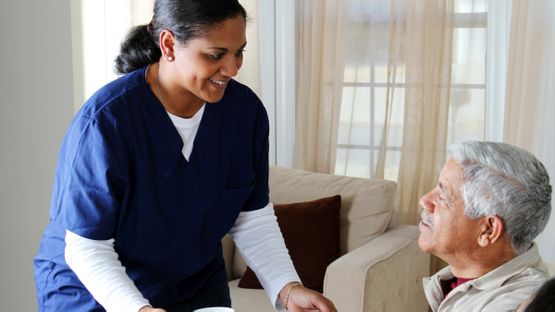 A young nurse taking care of an older man